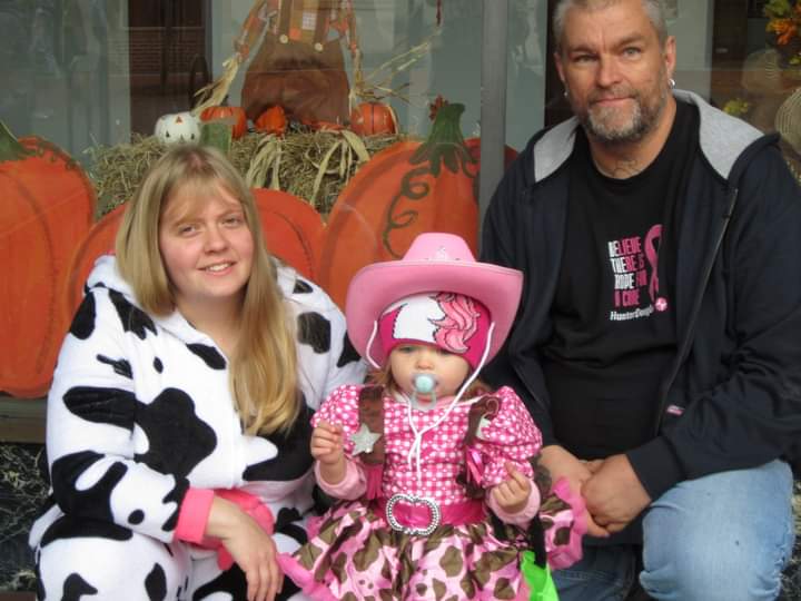 parents with little girl all dressed up for halloween